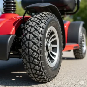 Close-up of the robust, treaded tires on an all terrain mobility scooter, highlighting their deep traction for various terrains.