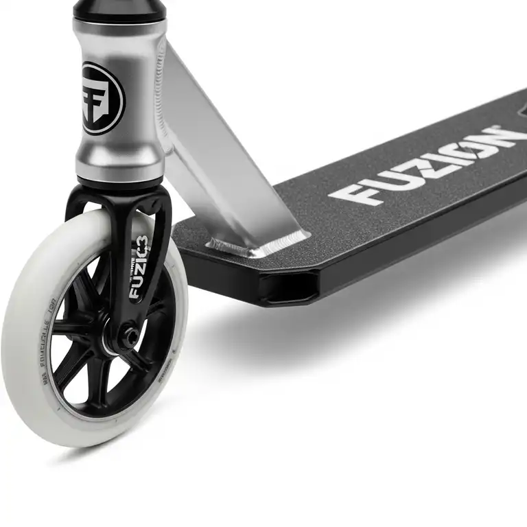 A close-up shot of a fuzion scooter's deck and front wheel, highlighting its sleek design and durable build.