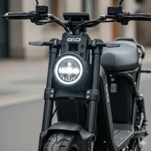 A detailed front view of the GIO electric scooter, highlighting its LED headlight and sturdy frame.
