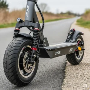 An image highlighting the Joyor scooter's robust front and rear suspension and solid tires, designed for a smooth and comfortable ride on various terrains.