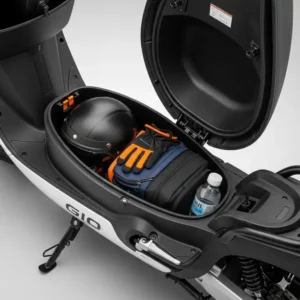 The under-seat storage compartment of a GIO electric scooter, highlighting its practicality for carrying personal items.